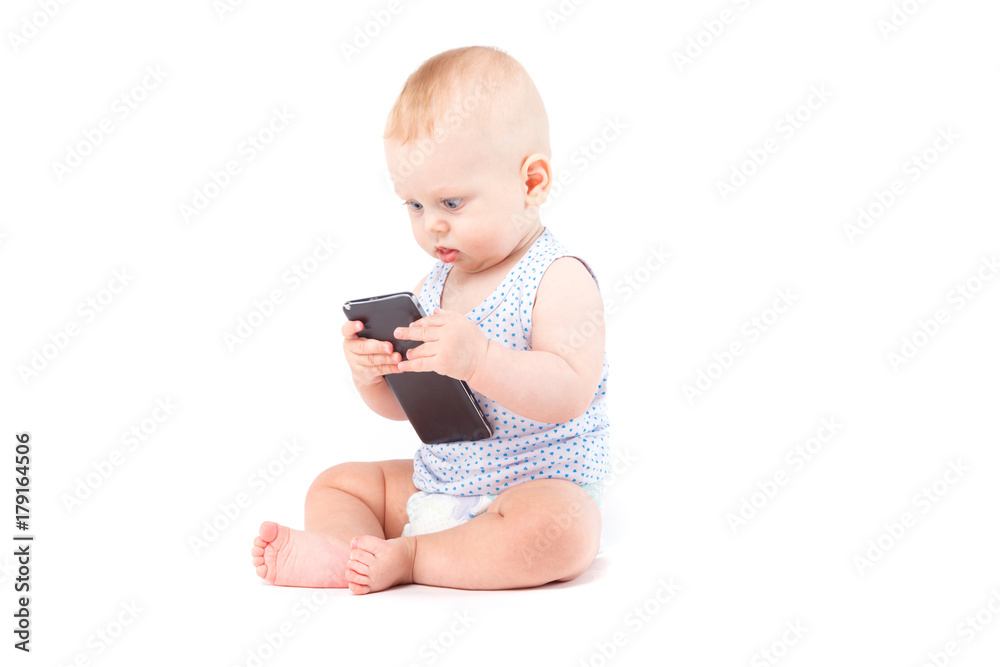 cute happy little boy in speckled shirt with cellphone cute happy little boy in speckled shirt with cellphone