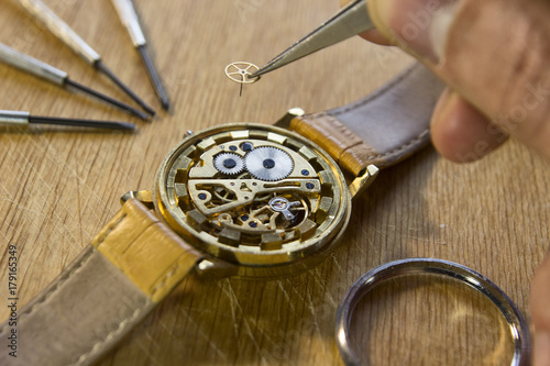 Watchmaker is repairing the mechanical watches in his workshop