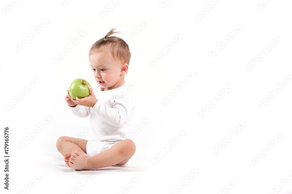 Fototapeta premium cute beauty little girl in white pijamas with apple