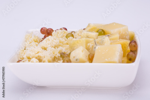 Set of cheeses and grapes on a white background