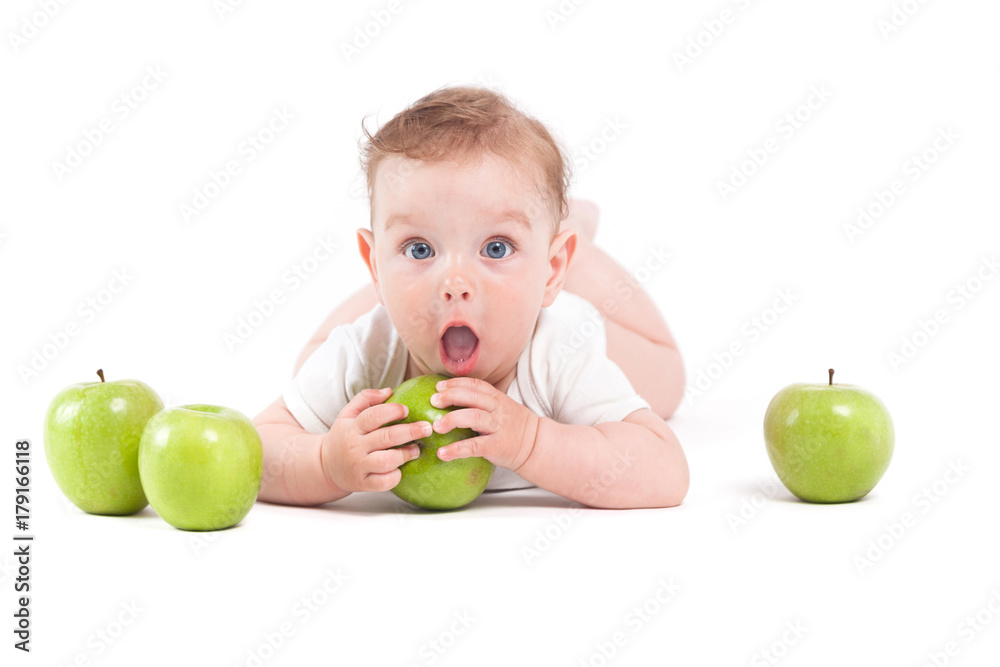 cute pretty baby boy in white shirt lies on tummy and hold green apple cute pretty baby boy in white shirt lies on tummy and hold green apple