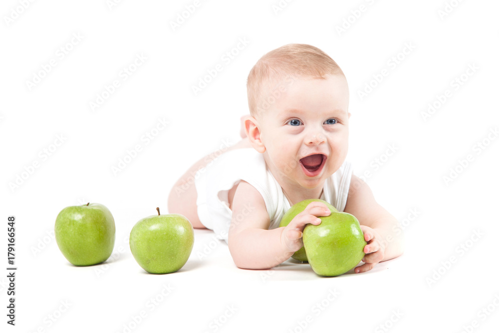 cute attractive baby boy in white shirt lies on tummy and hold green apple cute attractive baby boy in white shirt lies on tummy and hold green apple
