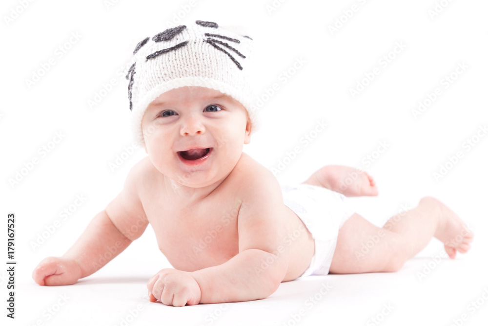 cute pretty baby boy in diaper and cat hat lies on tummy cute pretty baby boy in diaper and cat hat lies on tummy