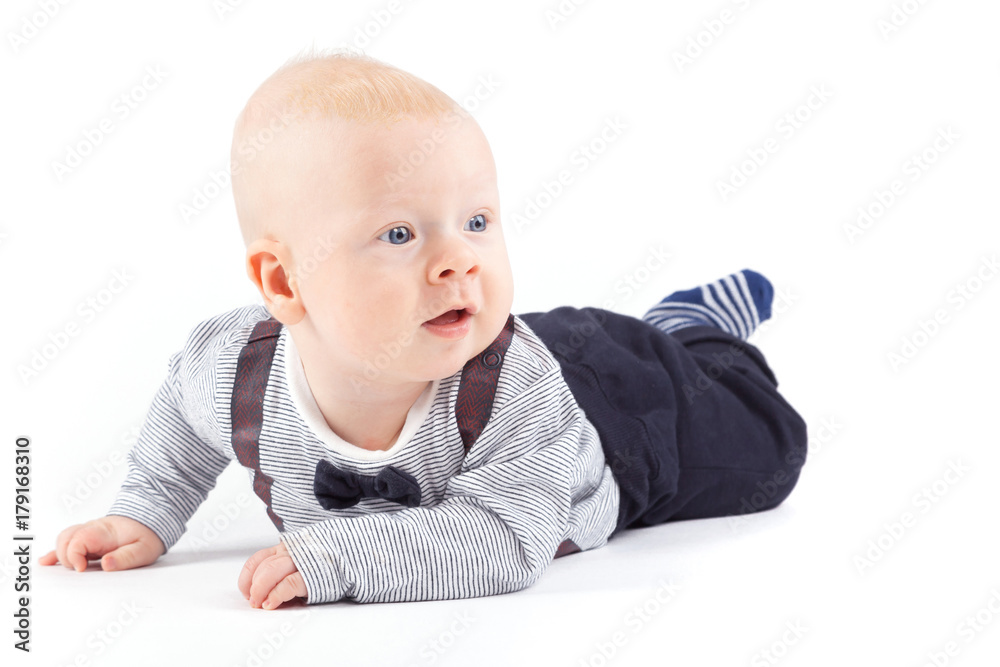 pretty cute baby boy in strong costume lies on tummy pretty cute baby boy in strong costume lies on tummy