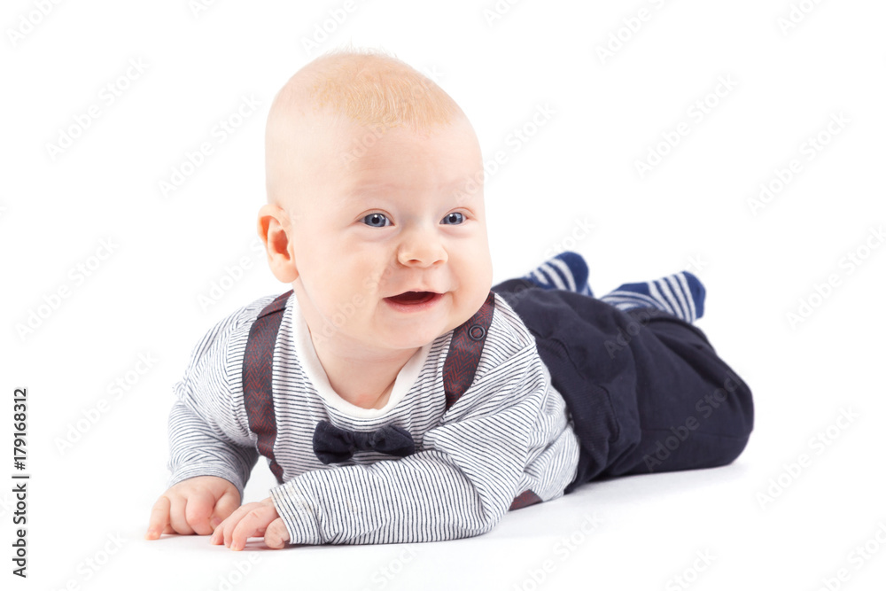pretty cute baby boy in strong costume lies on tummy pretty cute baby boy in strong costume lies on tummy