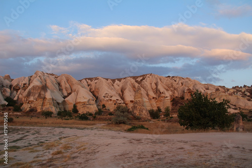 Natural valley with volcanic tuff stone rocks in Goreme in Cappadocia, Turkey, at sunset.