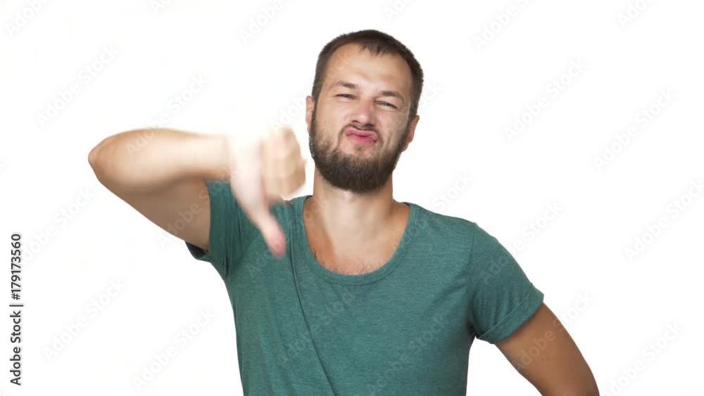 horizontal portrait of adult guy with short brown hair shaking head negatively showing dislike sign thumb down over white background closeup. Concept of emotions horizontal portrait of adult guy with short brown hair shaking head negatively showing dislike sign thumb down over white background closeup. Concept of emotions