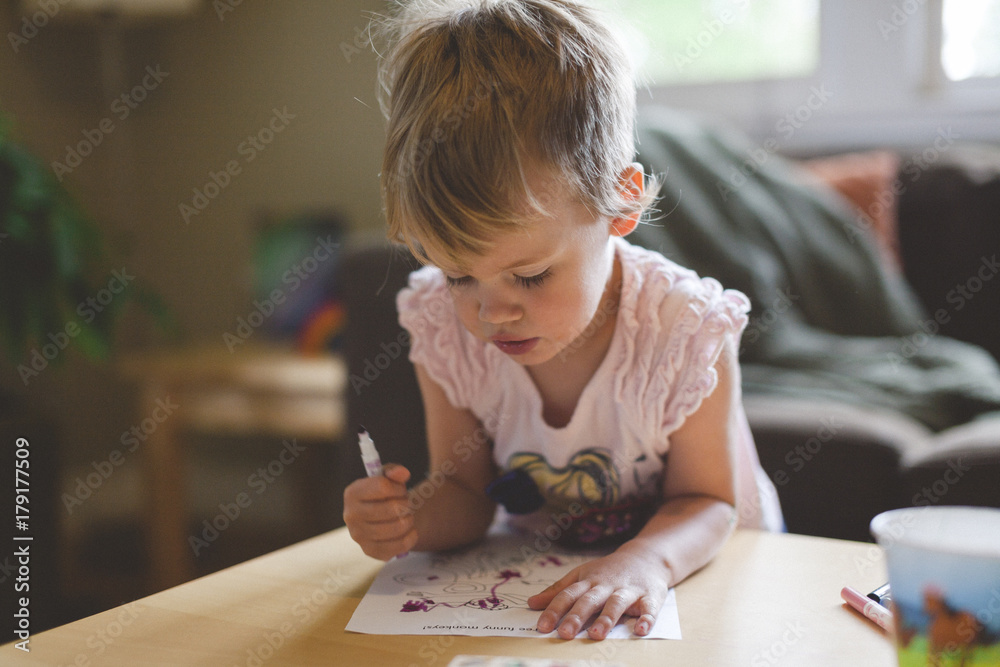 Cute toddler girl colouring a picture at home Cute toddler girl colouring a picture at home