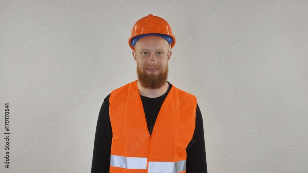 Portrait young candid professional worker. Man wearing in high visibility safety vest and a hard hat. Portrait young candid professional worker. Man wearing in high visibility safety vest and a hard hat.
