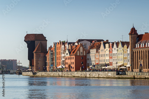View of the Crane and other old buildings along the Long Bridge waterfront at the Main Town in Gdansk, Poland, on a sunny day.