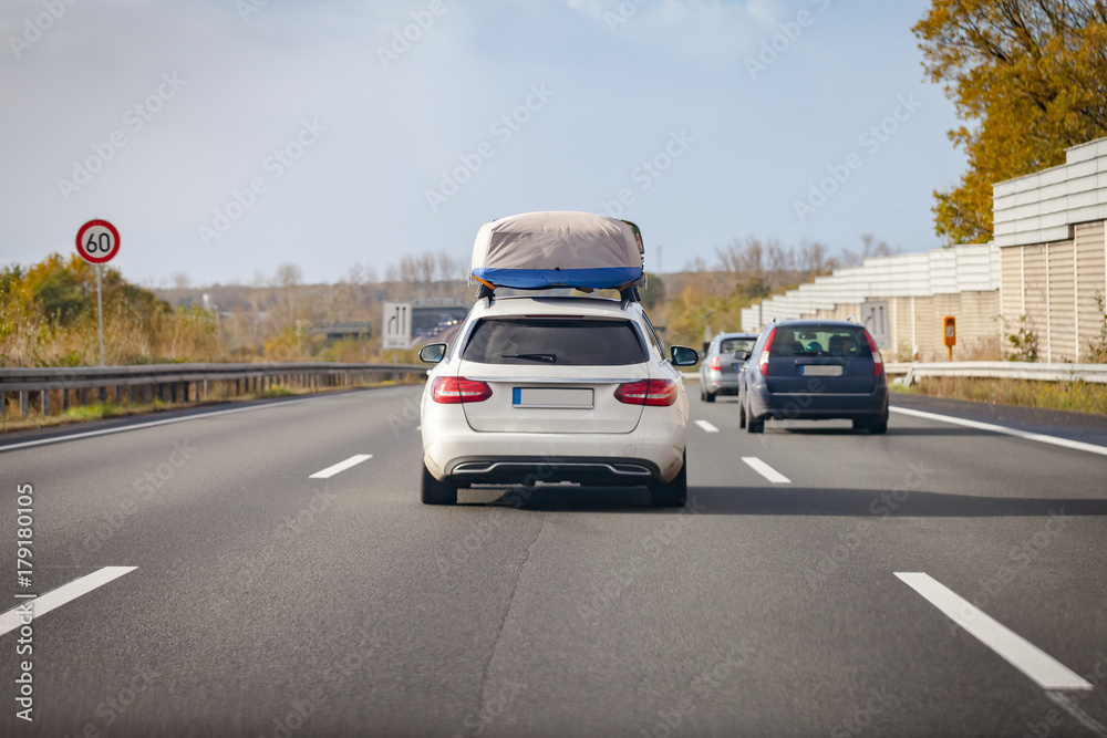 white car with porter drives on a german motorway white car with porter drives on a german motorway