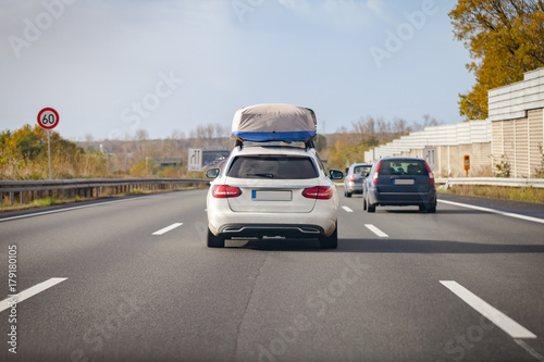 white car with porter drives on a german motorway
