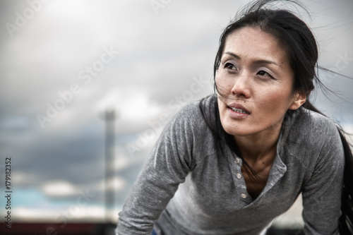 Athletic woman hunched over