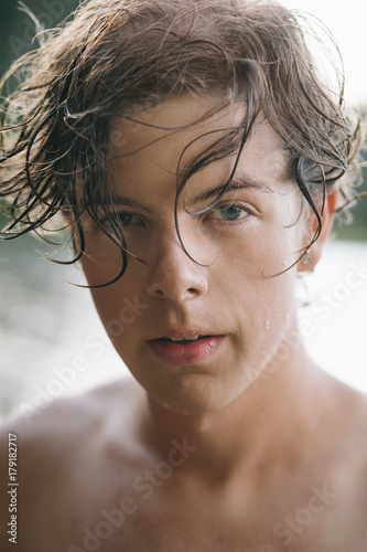 A portrait of a handsome young man with wet hait photo