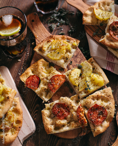 Italian Focaccia with potatoes and tomatoes photo