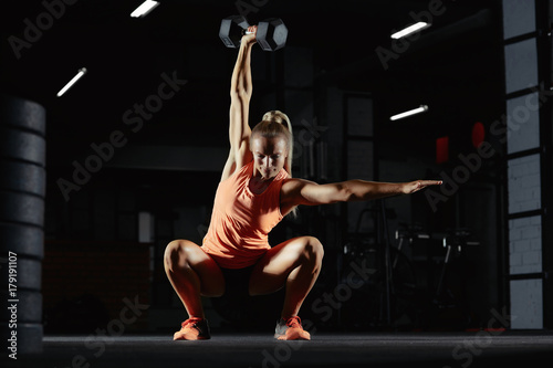 Female crossfit athlete exercising photo
