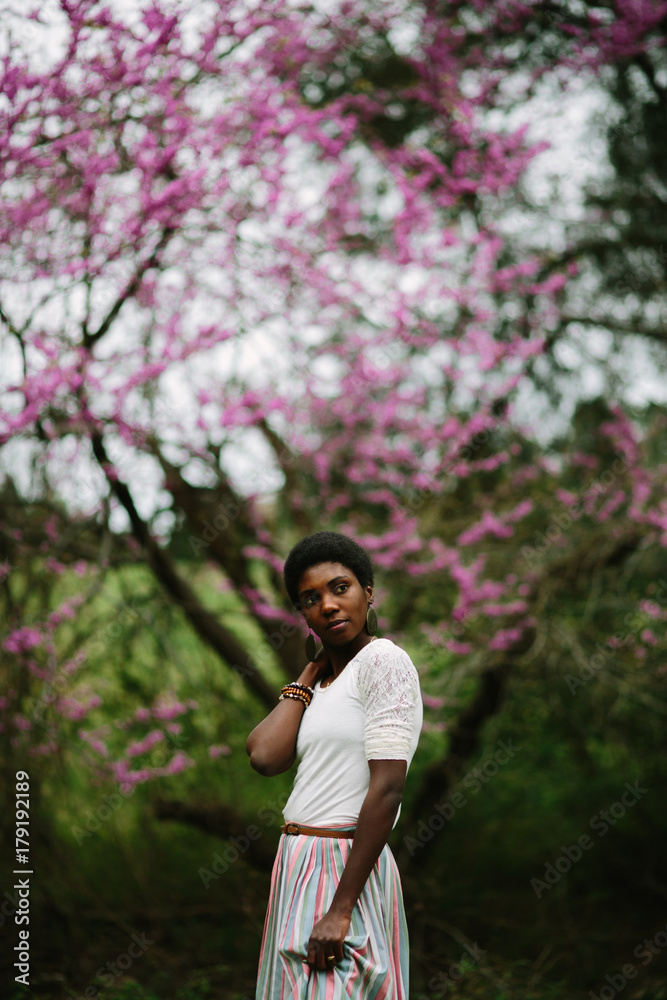 woman standing in front of pink tree woman standing in front of pink tree