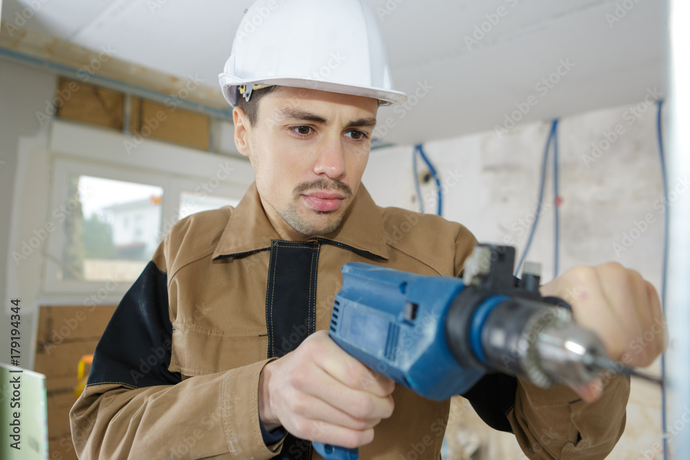man with drill or screwdriver and construction man with drill or screwdriver and construction