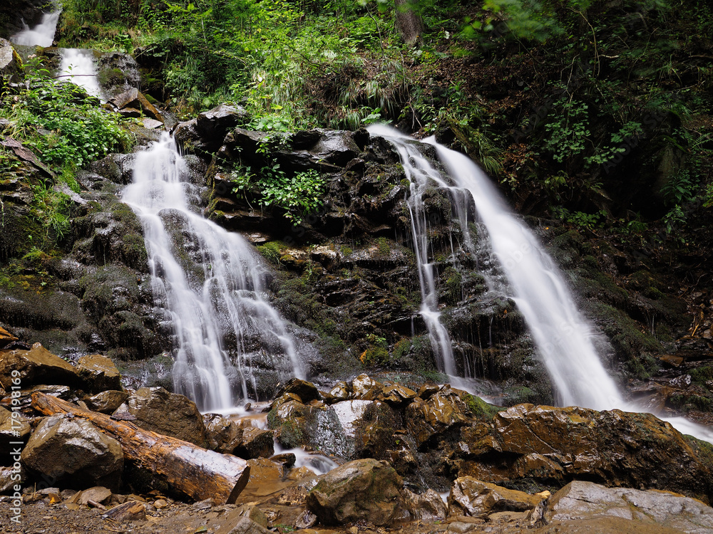 Obraz premium Waterfall at the carpatian mountains green forest