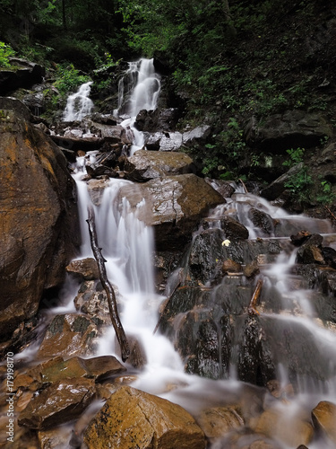Waterfall at the carpatian mountains green forest