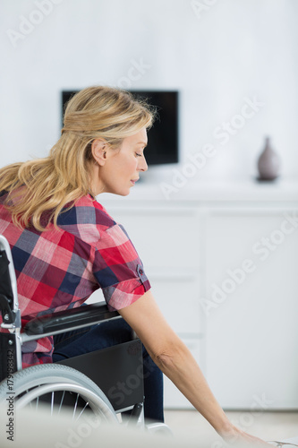 optimistic handicapped middle aged woman sitting on wheelchair