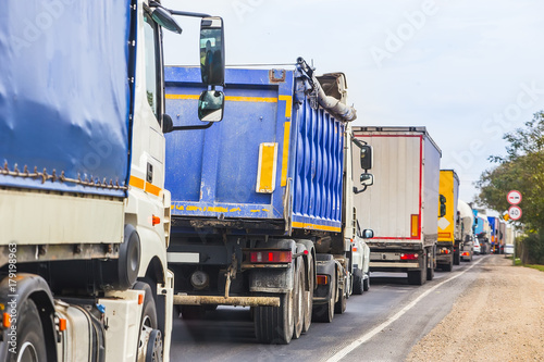 trucks in traffic jam on the road photo