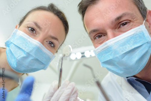 Portrait of male and female masked dental workers