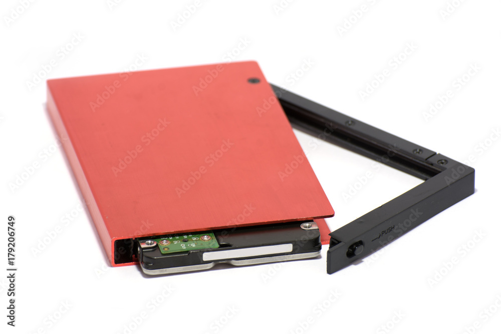 The hard disk is inserted into the red external hard disk.on white background. The hard disk is inserted into the red external hard disk.on white background.