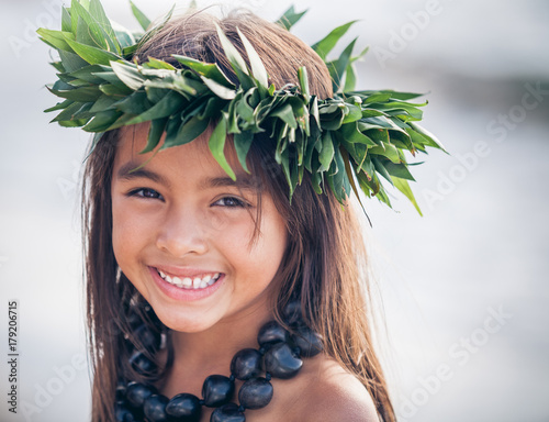 Portrait of a Smiling Young Traditional Hawaiian Hula Dancer Girl photo