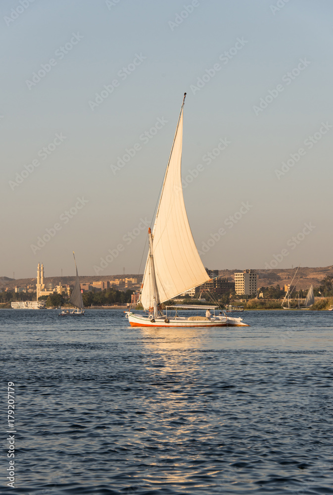 A boat sailing on the Nile at sunset. A boat sailing on the Nile at sunset.