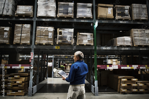 A Caucasian man checking stock inventory photo