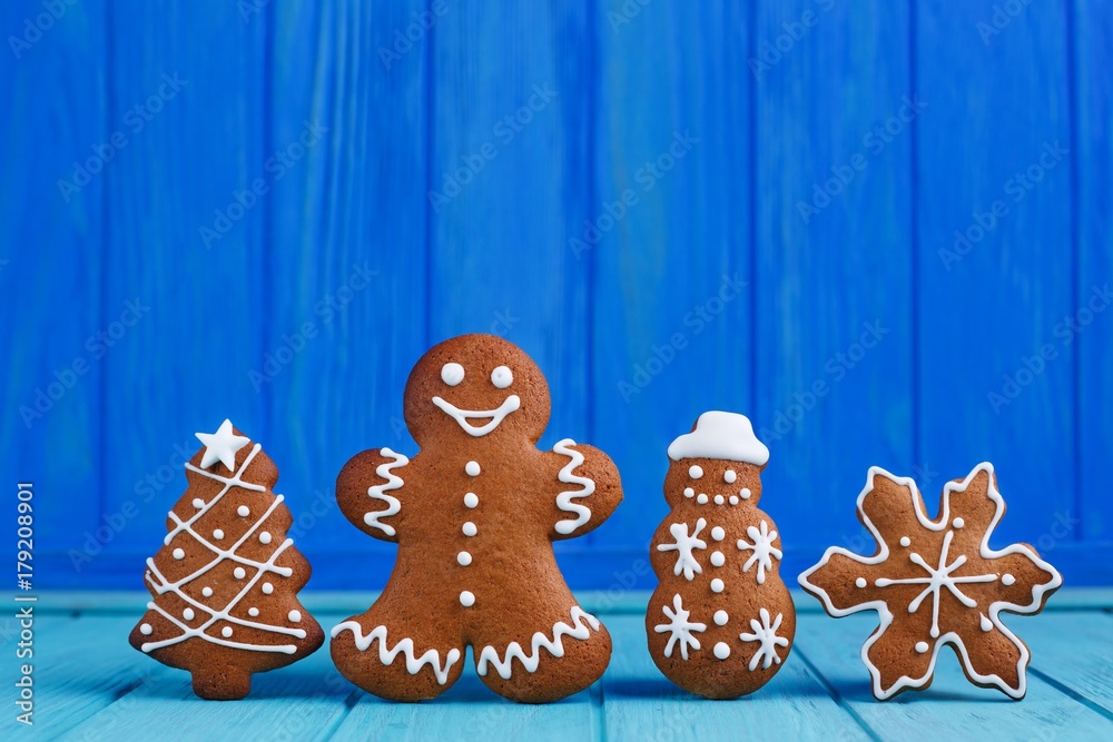 Christmas gingerbread cookies set on bright blue background. Christmas and New year traditions, winter holidays, homemade sweets, festive food