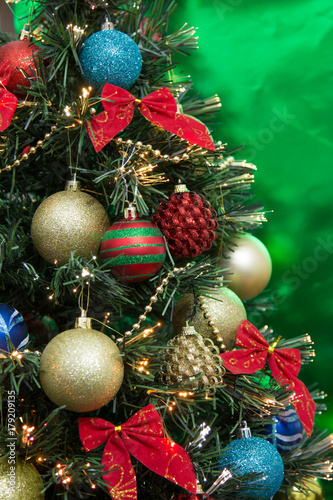 Christmas tree with ornaments and green background  vertical photo 