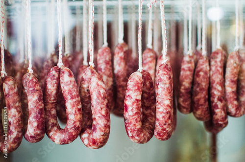 sausages curing and hanging by a string