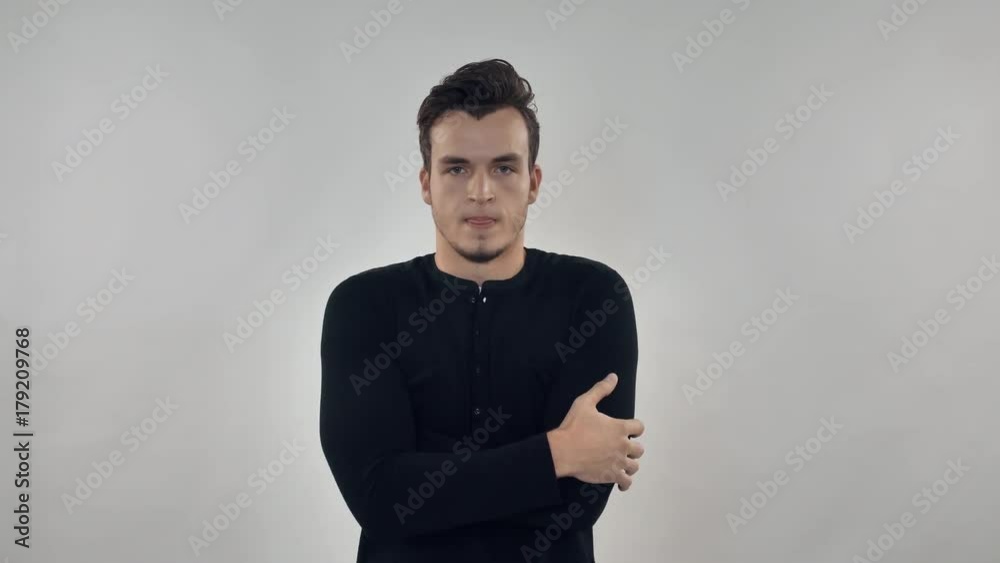 Portrait young man showing cold or chill. Caucasian guy freezes Portrait young man showing cold or chill. Caucasian guy freezes