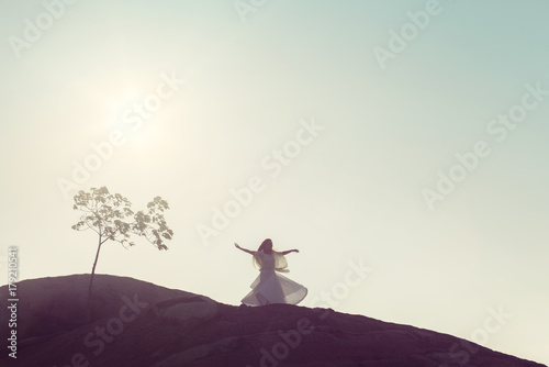 Young Woman Whirling Under the Open Sky photo