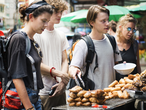 Photography A group of tourists buying Thai Food at food stall