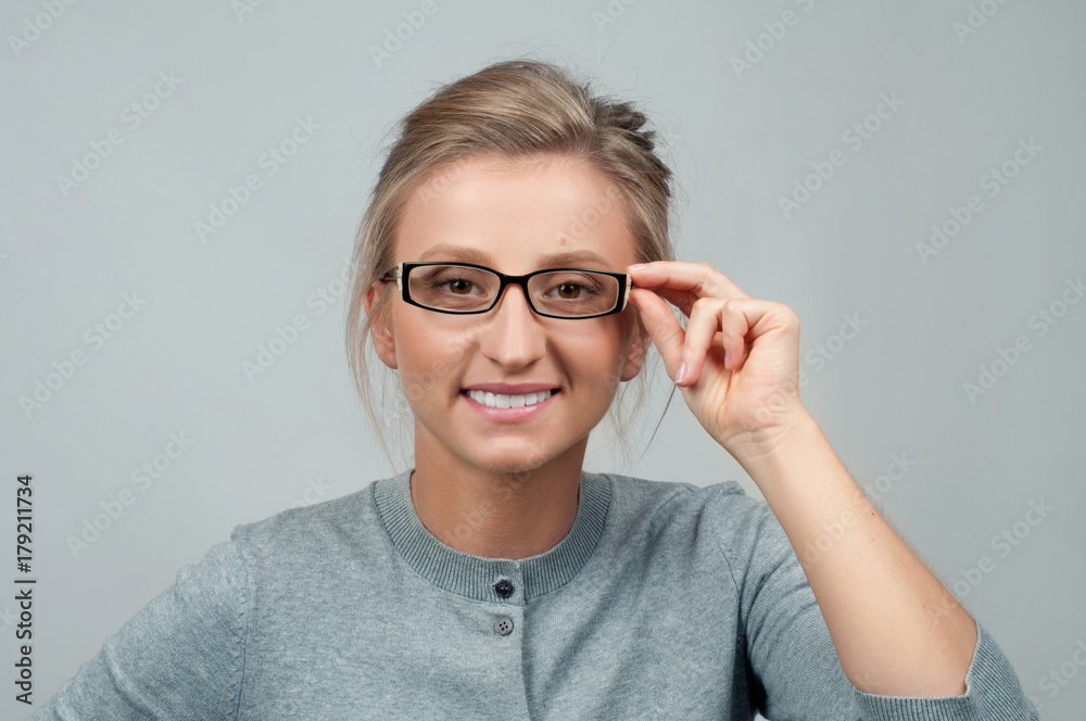 Young woman checking new eyeglasses Young woman checking new eyeglasses