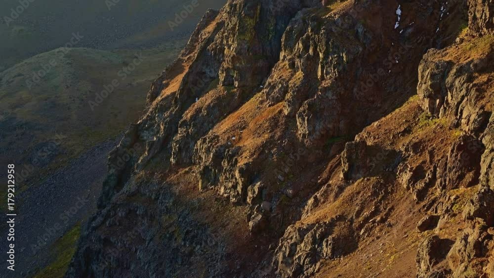 First dawn light at sunrise over barren desert mountain summit of Steens Mountain in fall near Malheur National Wildlife Refuge First dawn light at sunrise over barren desert mountain summit of Steens Mountain in fall near Malheur National Wildlife Refuge