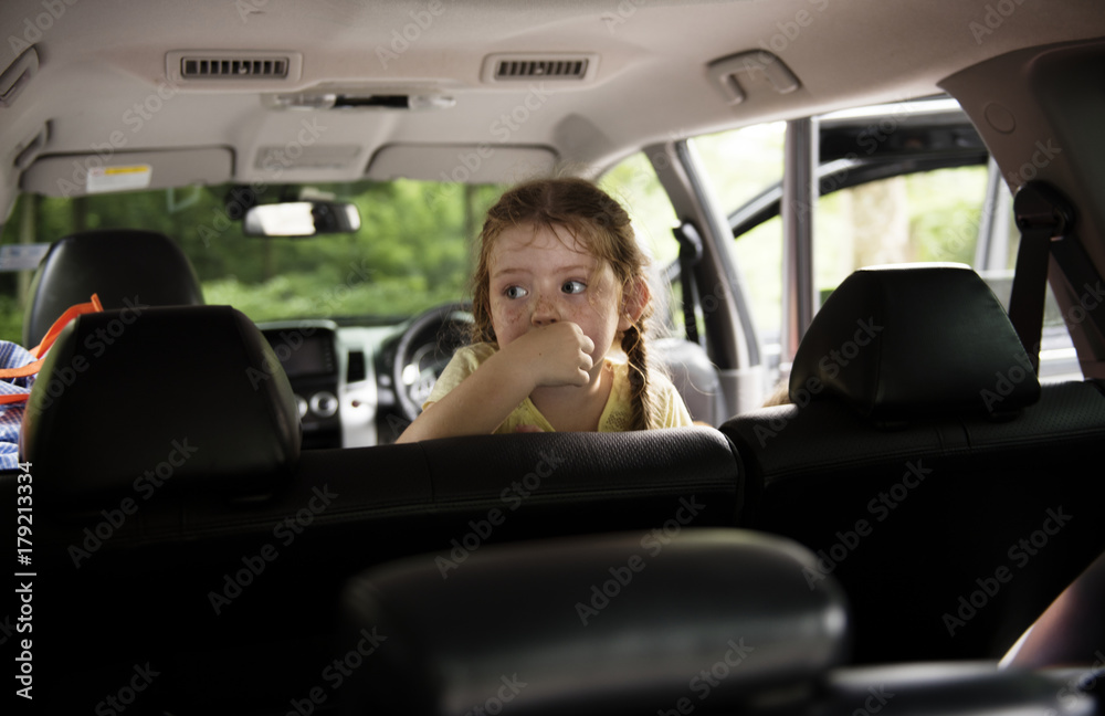 Young caucasian girl sitting thoughtful inside the car Young caucasian girl sitting thoughtful inside the car
