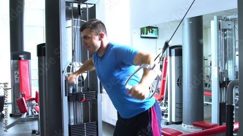 Handsome young man doing sports in the gym.