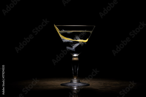 Transparent cocktail with lemon peel photo