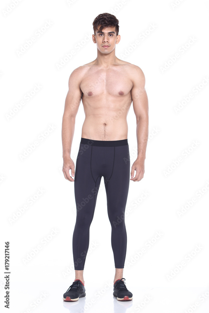 Full body length portrait of a young man wearing fitness sporty outfit