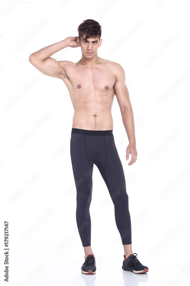 Full body length portrait of a young man wearing fitness sporty outfit