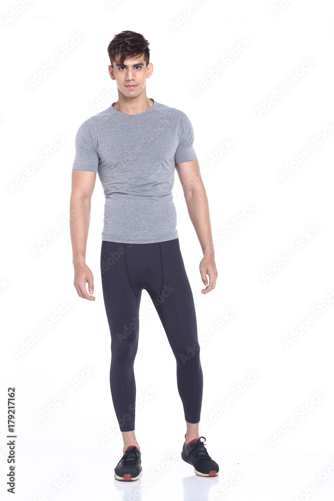 Full body length portrait of a young man wearing fitness sporty outfit Full body length portrait of a young man wearing fitness sporty outfit