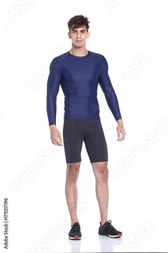 Full body length portrait of a young man wearing fitness sporty outfit © Jade