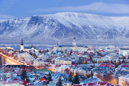 Iceland, Reykjavik, elevated view over the Churches and cityscape of Reykjavik with a backdrop of snow capped mountains photo