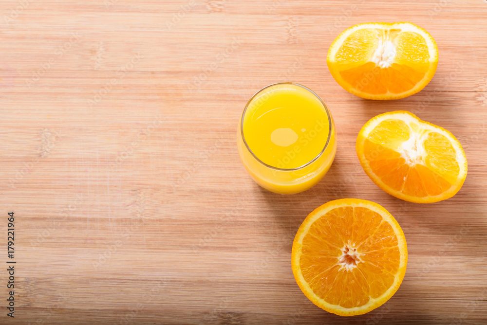 glass of fresh orange juice with orange slices on a wooden background glass of fresh orange juice with orange slices on a wooden background