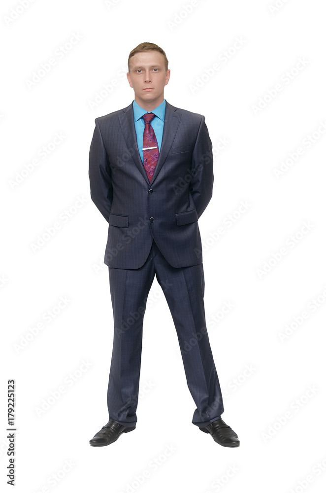 Business man stands holding his hands behind his back isolated on white background. Business man stands holding his hands behind his back isolated on white background.