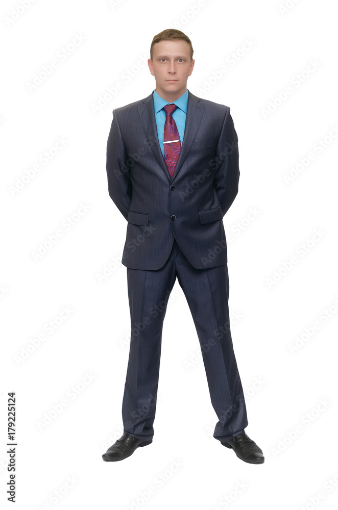 Business man stands holding his hands behind his back isolated on white background. Business man stands holding his hands behind his back isolated on white background.